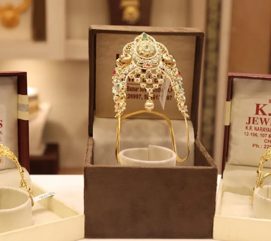 A stone set vanki armlet on its stand, in the shop's own presentation box.